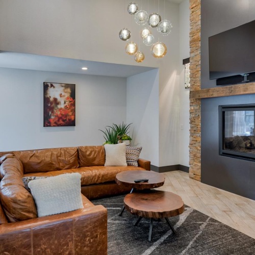 a lounge with a couch, tv and a fireplace