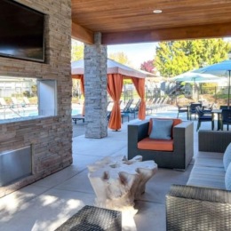 a patio with chairs and a tv
