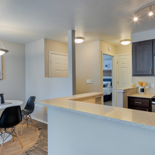 a kitchen with a dining table and chairs