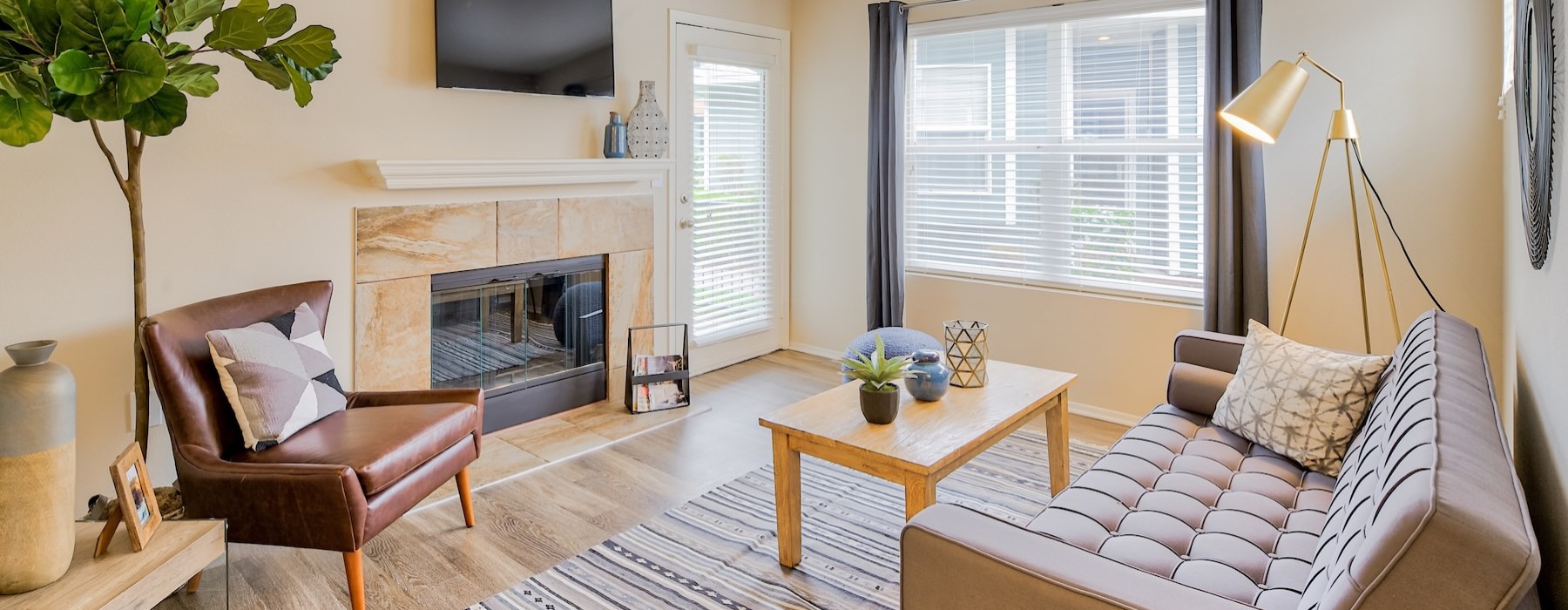 a living room with a couch, tv and a fireplace
